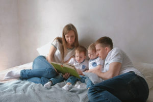 Parents teaching Bible to children
