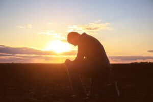 man praying at sunset prepare your heart