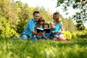 family reading Bible outside