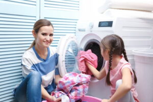 finding joy in your everyday life woman doing laundry with little girl