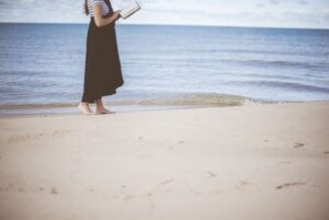 preparation of the Gospel woman reading Bible on beach